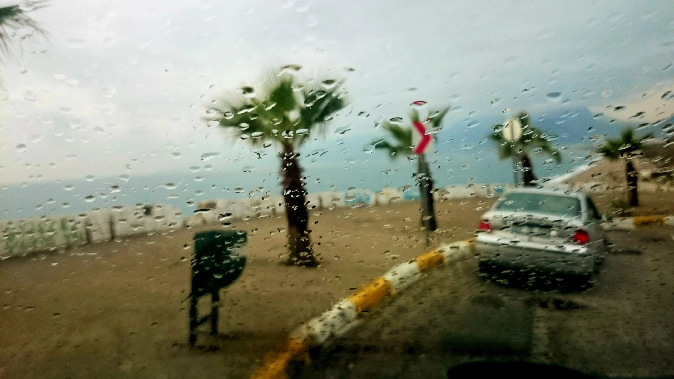 car-road-seen-through-wet-windshield-rainy-day